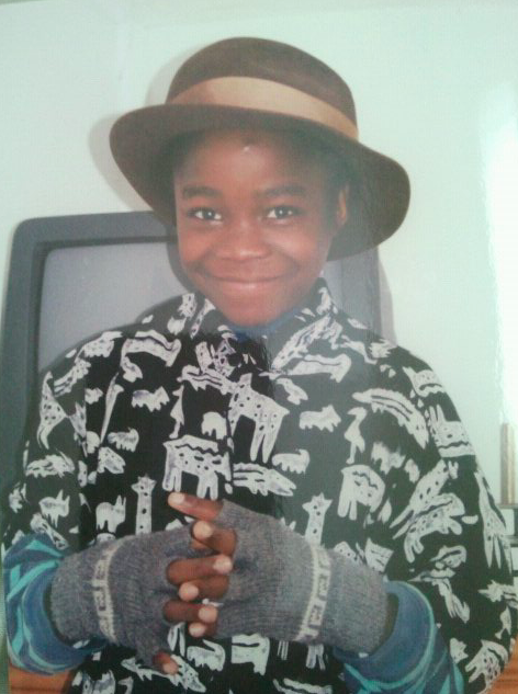 Marcelle Hutchins at 8, in a hat and gloves, smiling